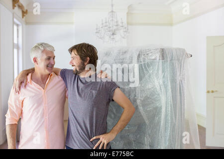 Father and son hugging in living space Stock Photo