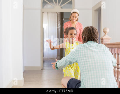 Father and daughter embracing in living space Stock Photo