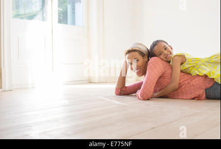 Mother and daughter relaxing in living space Stock Photo