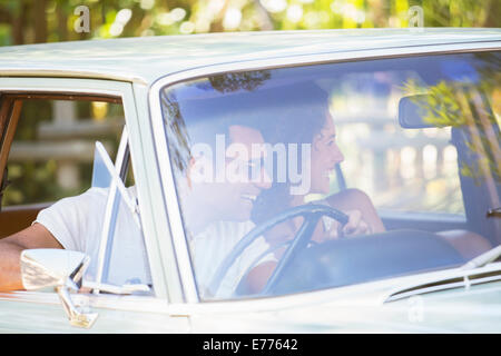 Couple enjoying car ride on sunny day Stock Photo