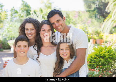 Family hugging outdoors Stock Photo