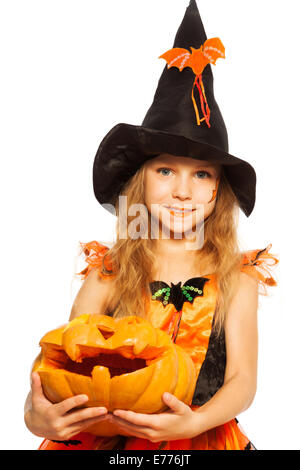 Close-up girl with pumpkin in witch dress Stock Photo