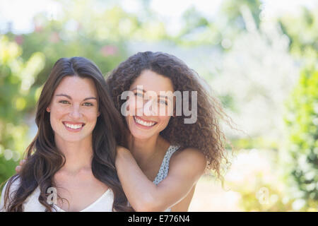 Sisters smiling together outdoors Stock Photo