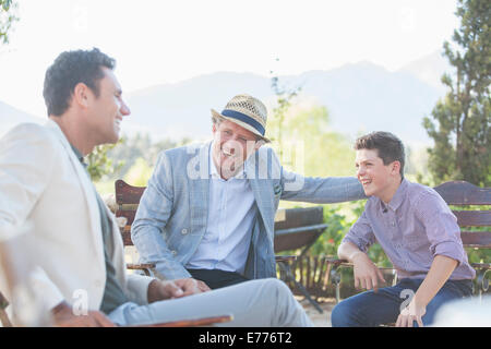 Three generations of men relaxing outdoors Stock Photo