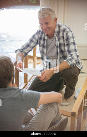 Father and son building furniture from instructions Stock Photo
