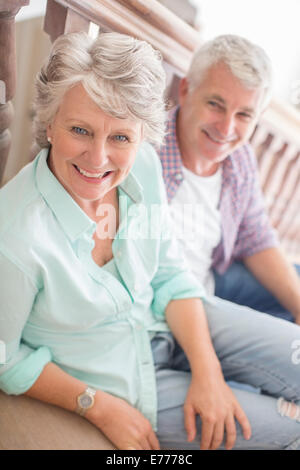 Older couple sitting together on stairs Stock Photo