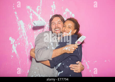 Couple playing with painting wall Stock Photo