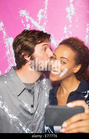 Couple playing and taking picture on cell phone Stock Photo