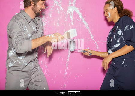 Couple playing with paint together Stock Photo