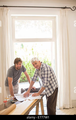 Father and son looking through documents together Stock Photo