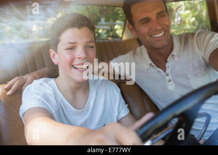 Father teaching son to drive Stock Photo