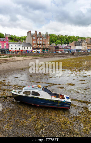 Beached boat on Oban Bay Beach and view towards George Street, Oban, Argyll & Bute, Scotland, UK  Model Release: No.  Property Release: No. Stock Photo