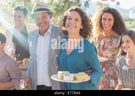 Older couple hugging at family picnic Stock Photo