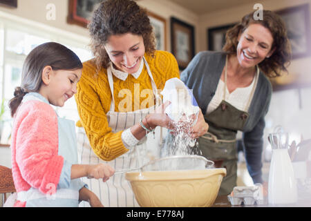 Three generations of woman baking together Stock Photo