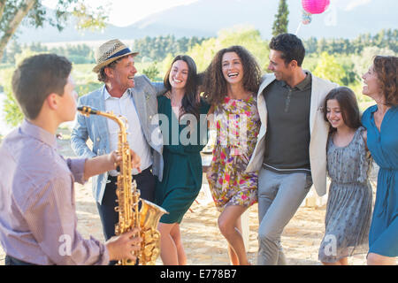 Family dancing together outdoors Stock Photo