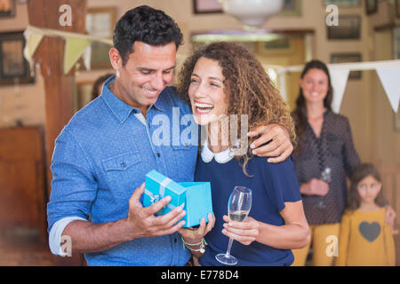 Couple opening gift together Stock Photo