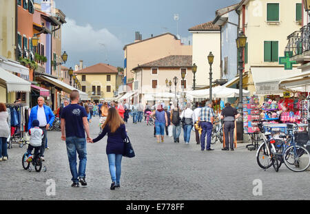 Caorle, Veneto, Italy . May 2014,  People walks and rides on bikes in the Caorle old town centre Stock Photo