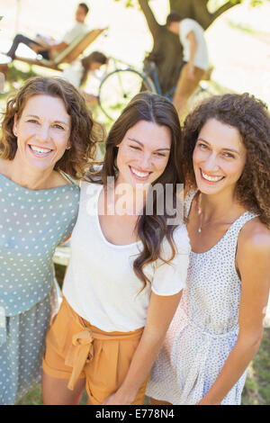 Mother and daughters hugging outdoors Stock Photo
