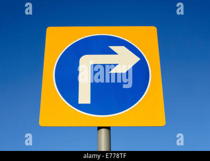 Turn right road sign set against a blue sky Stock Photo