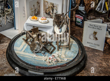 Taxidermy mice in tea party scene recreating Beatrix Potter story 'The Tale of Two Bad Mice' Stock Photo