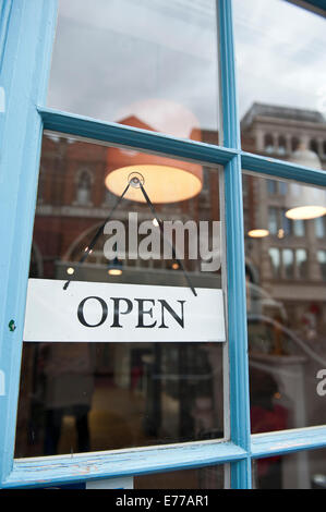 An open sign in a shop window door Stock Photo