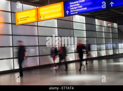 Passengers walking in illuminated passageway in Interior of Potsdamer Platz railway station in Berlin Germany Stock Photo