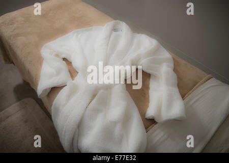 Soft Robe On Massage Table At Spa Stock Photo