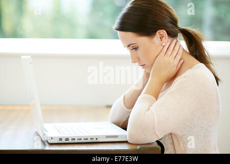 Tired girl working from home Stock Photo
