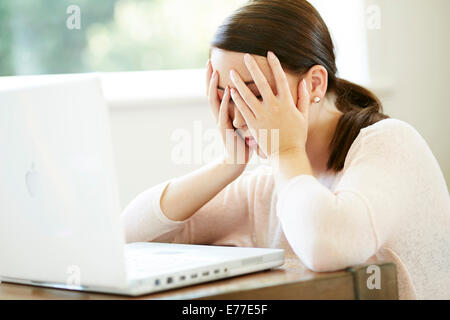 Tired girl working from home Stock Photo