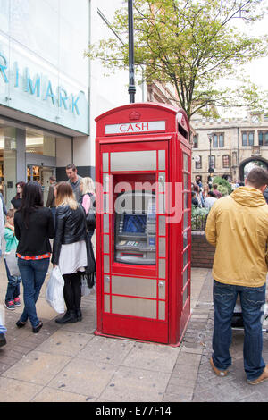 A traditional British telephone box converted into a cash machine Stock Photo