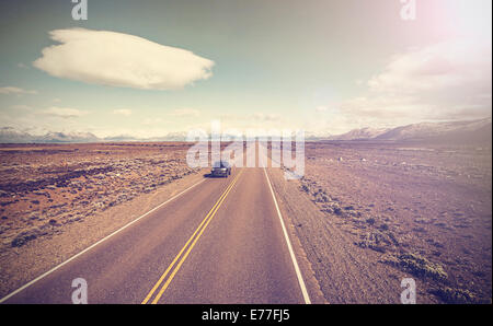Vintage picture of car on endless country highway, Ruta 40 in Argentina. Stock Photo