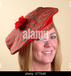 Portrait of a smiling woman wearing a Tam o Shanter Scottish hat Stock Photo