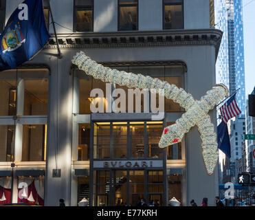 New York Bulgari illuminated serpent, seasonal Christmas decorations on the exterior of their upscale boutique store on 5th Avenue, downtown New York Stock Photo