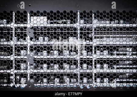 Rows of circuit boards inside a high end router computer with capacitors visible through honeycomb case Stock Photo