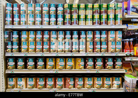 A natural foods grocery store aisle with cans of organic beans. Stock Photo