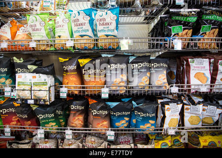 A natural foods grocery store aisle with shelves of natural potato chips. Stock Photo