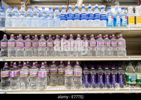 A natural foods grocery store aisle with shelves of bottled water. Stock Photo