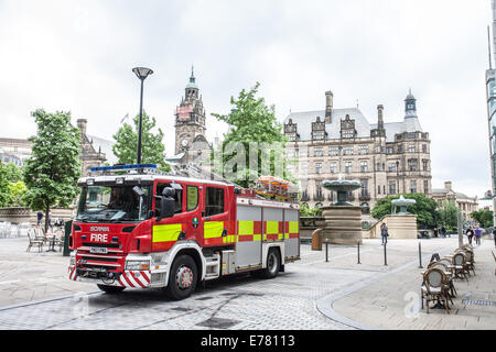 A fire engine in the snow in the peace gardens outside Sheffield town hall, South Yorkshire England UK Stock Photo