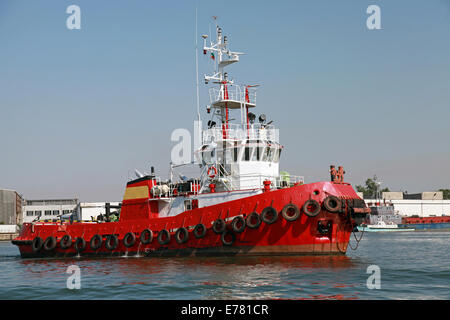 Red tug is underway on Black sea, Bulgaria Stock Photo