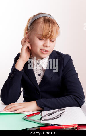 Portrait of tired blond Caucasian schoolgirl with headache Stock Photo