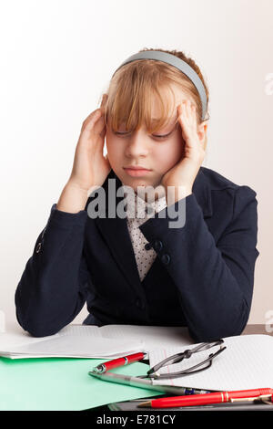 Portrait of blond Caucasian schoolgirl with headache Stock Photo