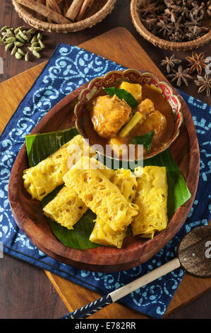 Roti jala with kari ayam. Lacy pancakes with chicken curry. Malaysia Food Stock Photo