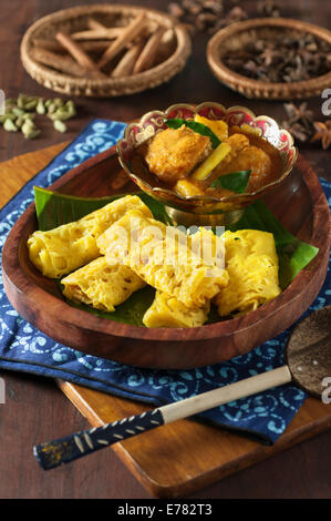 Roti jala with kari ayam. Lacy pancakes with chicken curry. Malaysia Food Stock Photo