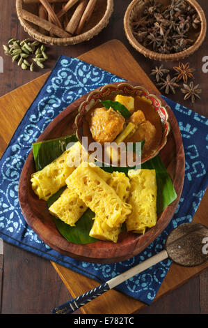 Roti jala with kari ayam. Lacy pancakes with chicken curry. Malaysia Food Stock Photo