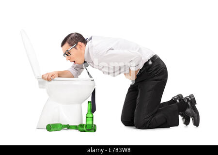 Drunk man throwing up in a toilet isolated on white background Stock Photo