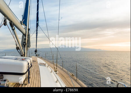 Sailing boat under power in calm seas Stock Photo