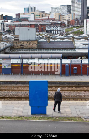 A man on a platform Sheffield railway station in Sheaf Square, Sheffield City Centre, Yorkshire Stock Photo