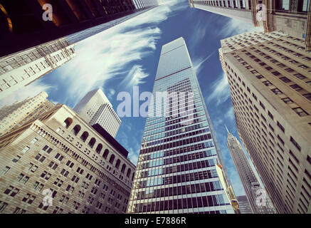 Retro filtered view of skyscrapers in Lower Manhattan, looking up at sky, New York City. Stock Photo