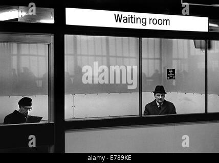 Waiting room Waterloo, 5.30pm. The flow of evening commmuters is reflected in the windows. Stock Photo