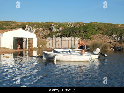 Local fisherman on his fishing boat at Sanitja, near Fornells, Menorca, Spain Stock Photo